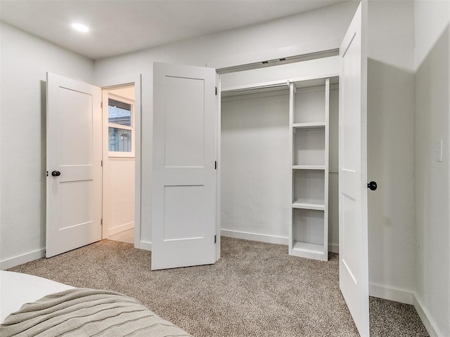 unfurnished bedroom featuring carpet floors and a closet