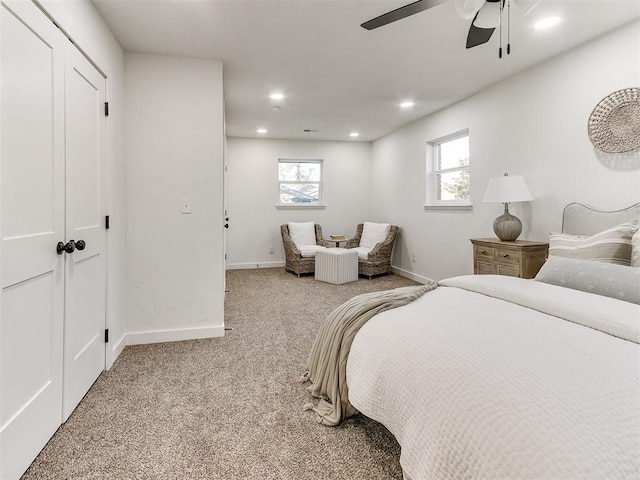 carpeted bedroom with a closet and ceiling fan