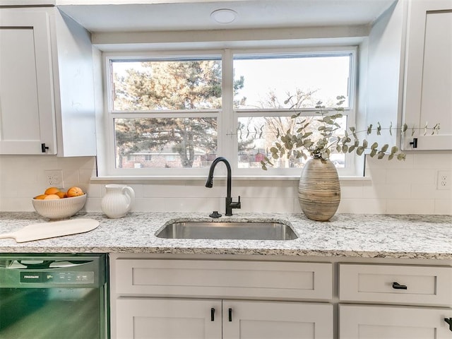 details with sink, black dishwasher, light stone countertops, decorative backsplash, and white cabinets