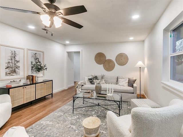 living room featuring hardwood / wood-style flooring, ceiling fan, and a healthy amount of sunlight