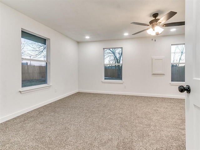 carpeted spare room with ceiling fan