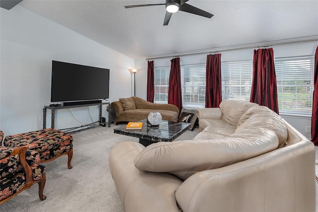 living room with carpet floors, ceiling fan, and vaulted ceiling