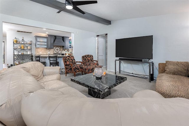 carpeted living room with sink, lofted ceiling with beams, and ceiling fan