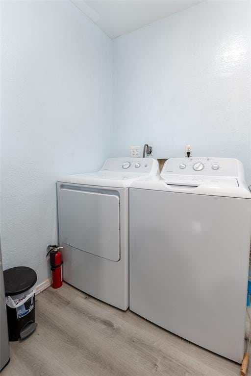 laundry area featuring light hardwood / wood-style floors and washer and dryer