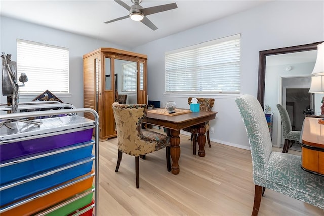 dining area with ceiling fan and light hardwood / wood-style floors