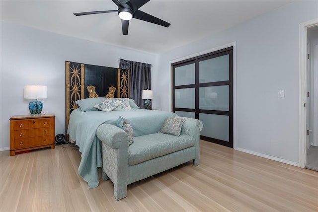 bedroom with light wood-type flooring and ceiling fan