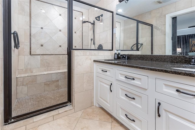 bathroom with vanity, a shower with shower door, and tile patterned floors