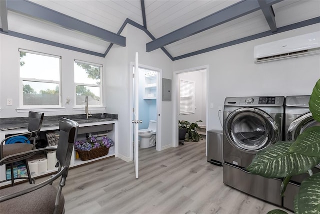 laundry room with separate washer and dryer, light hardwood / wood-style flooring, sink, and a wall mounted AC