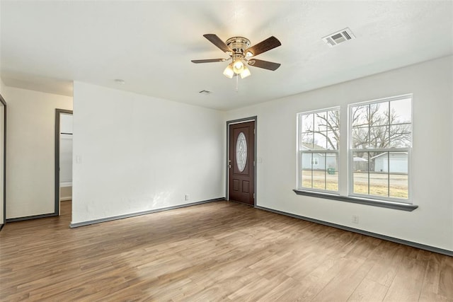 foyer entrance with ceiling fan and light hardwood / wood-style floors