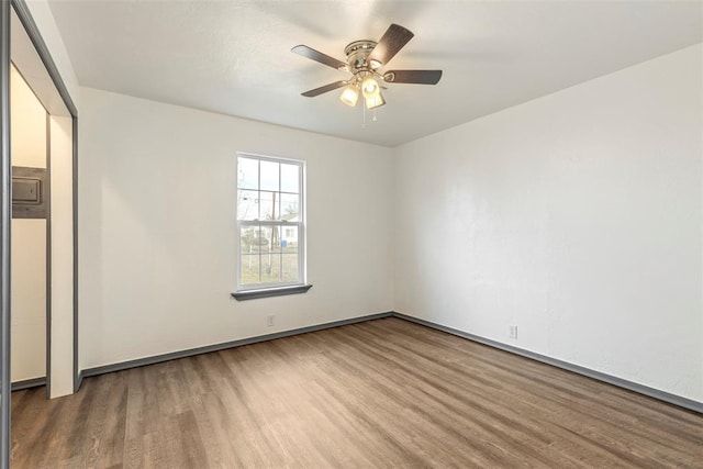 spare room featuring ceiling fan and wood-type flooring