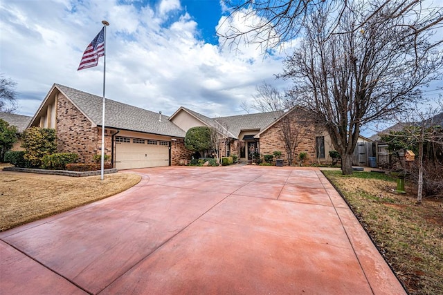 ranch-style home featuring a garage and a front lawn