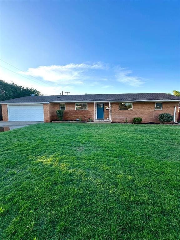 ranch-style house with a garage and a front lawn