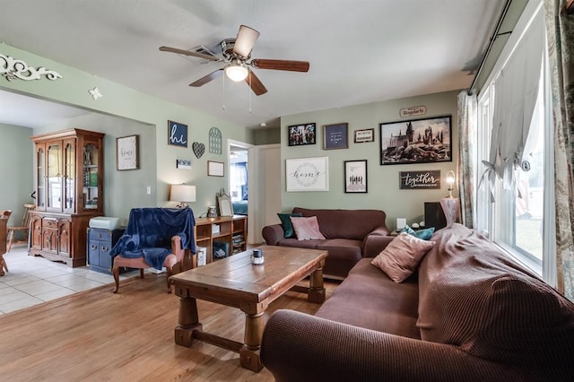 living room featuring ceiling fan and light hardwood / wood-style floors