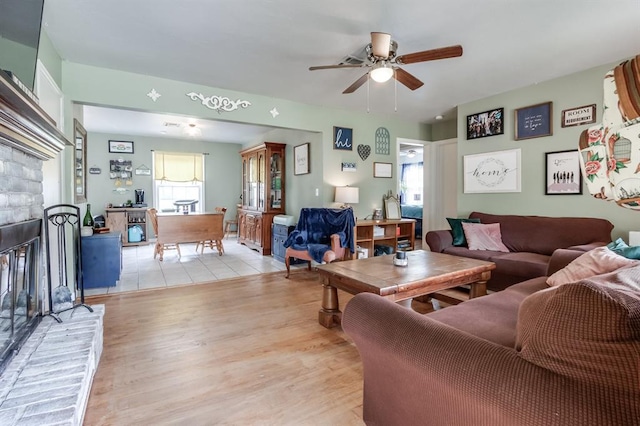 1815 N Bell Ave, Shawnee, OK 74804 - living area with ceiling fan, light wood finished floors, and a brick fireplace
