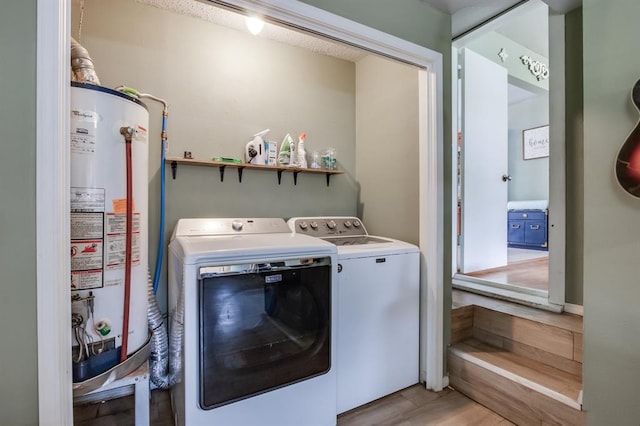 1815 N Bell Ave, Shawnee, OK 74804 - washroom with gas water heater, separate washer and dryer, and light wood-style floors