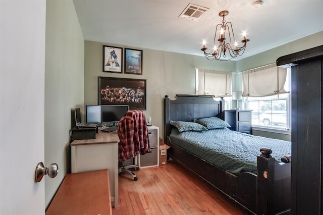 1815 N Bell Ave, Shawnee, OK 74804 - bedroom with a chandelier, wood finished floors, and an office area