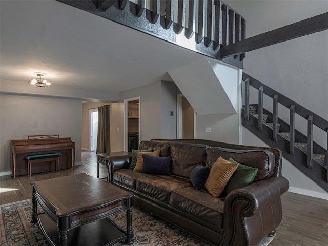 living room with hardwood / wood-style flooring and an inviting chandelier