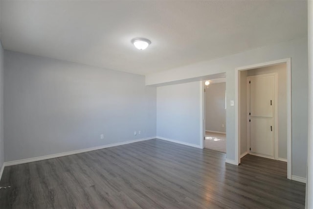 unfurnished room with dark hardwood / wood-style floors