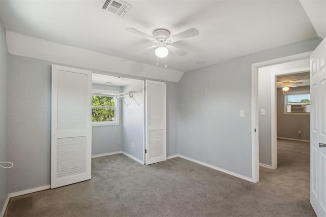 unfurnished bedroom with light carpet, ceiling fan, a closet, and vaulted ceiling