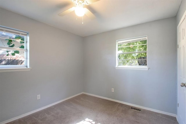 carpeted empty room featuring ceiling fan