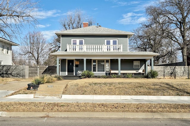 front facade with a porch and a balcony