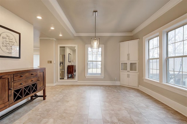 dining area with ornamental molding and a healthy amount of sunlight