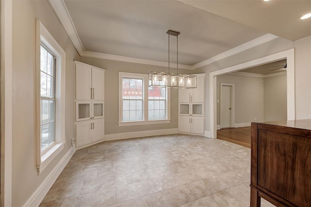 unfurnished dining area featuring ceiling fan and ornamental molding