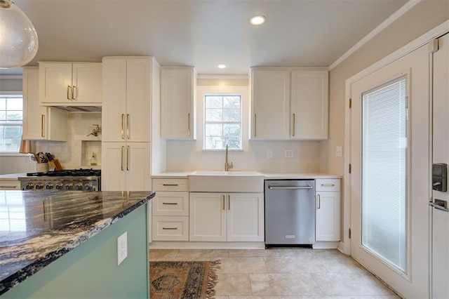 kitchen featuring stainless steel dishwasher, white cabinets, sink, and range