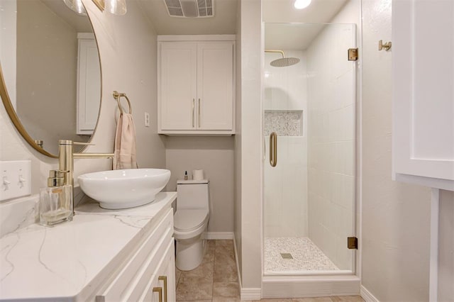 bathroom with toilet, tile patterned floors, a shower with shower door, and vanity