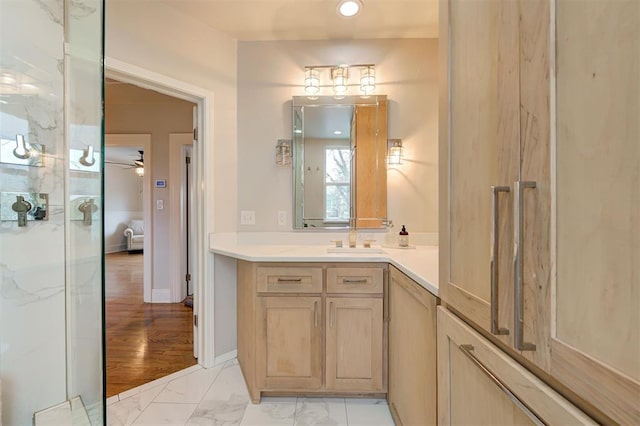 bathroom with ceiling fan and vanity