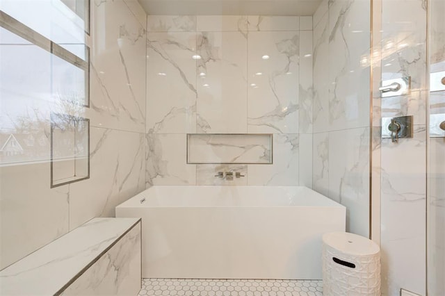 bathroom featuring a tub and tile walls