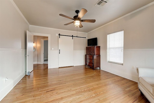 unfurnished bedroom with ceiling fan, crown molding, and light hardwood / wood-style floors