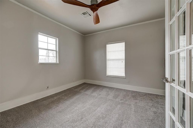 carpeted spare room featuring ceiling fan and crown molding