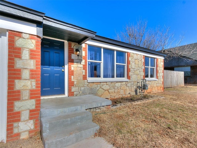 entrance to property with a lawn