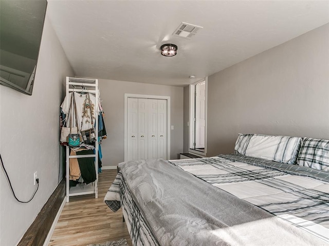 bedroom featuring light hardwood / wood-style floors and a closet