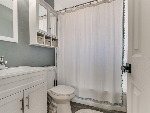 bathroom featuring toilet and vanity