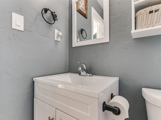 bathroom with toilet and vanity