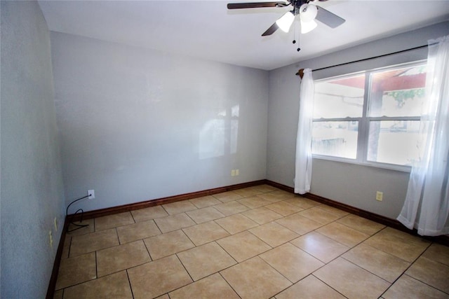 tiled spare room with ceiling fan