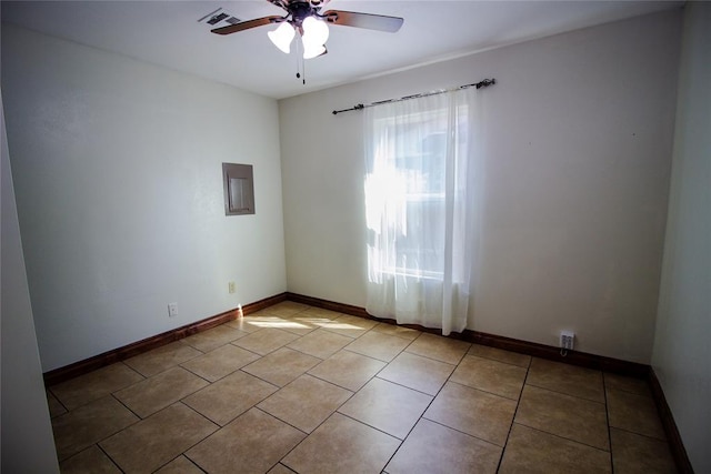 spare room featuring ceiling fan and light tile patterned flooring