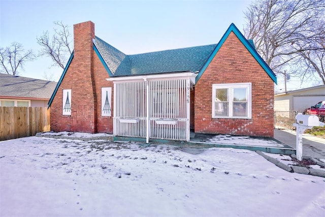 view of snow covered rear of property