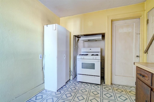 kitchen with gas range gas stove and range hood