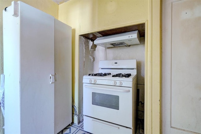 kitchen with wall chimney range hood and white gas range