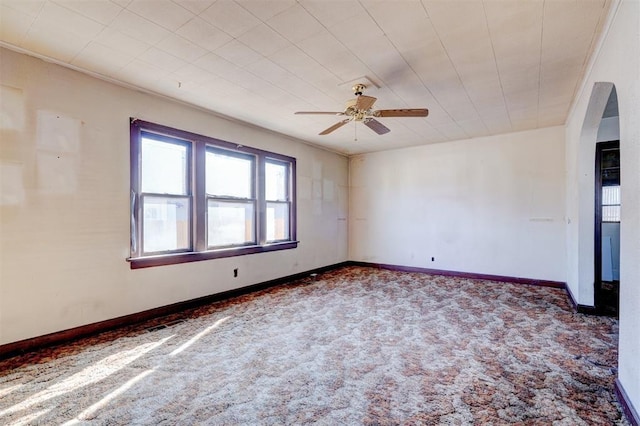 carpeted empty room featuring ceiling fan