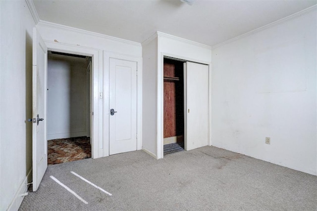 unfurnished bedroom with a closet, carpet, and crown molding