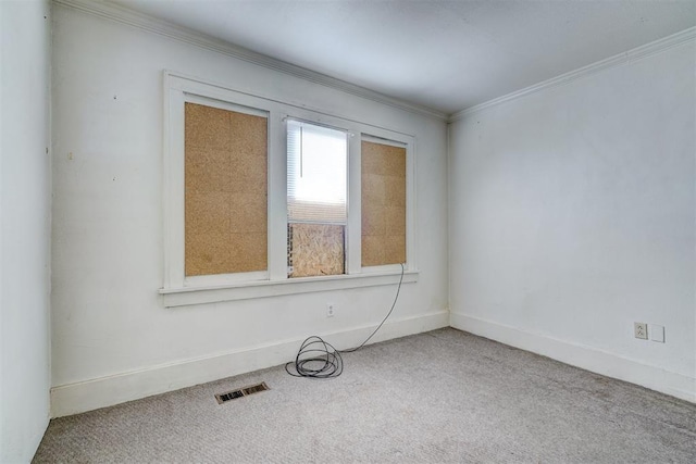 carpeted spare room with crown molding