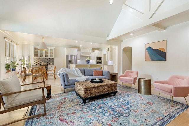 living room with lofted ceiling and light hardwood / wood-style flooring