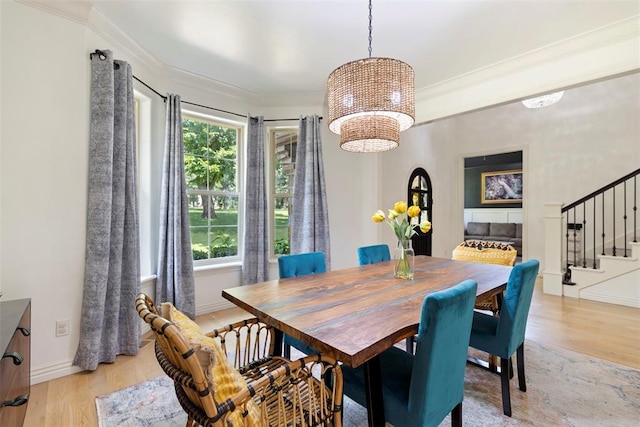 dining area featuring crown molding and light hardwood / wood-style floors