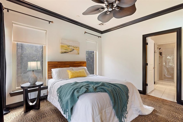 bedroom featuring crown molding, light colored carpet, and ensuite bath