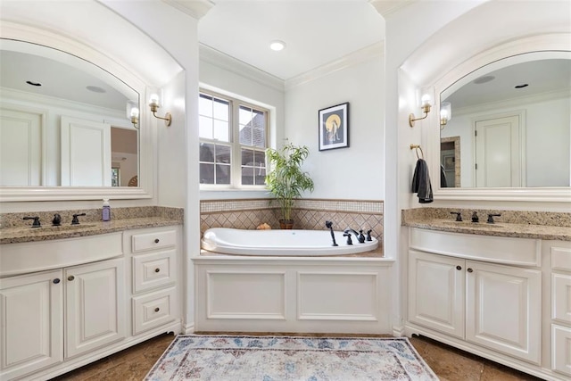 bathroom featuring vanity, crown molding, and a bathing tub