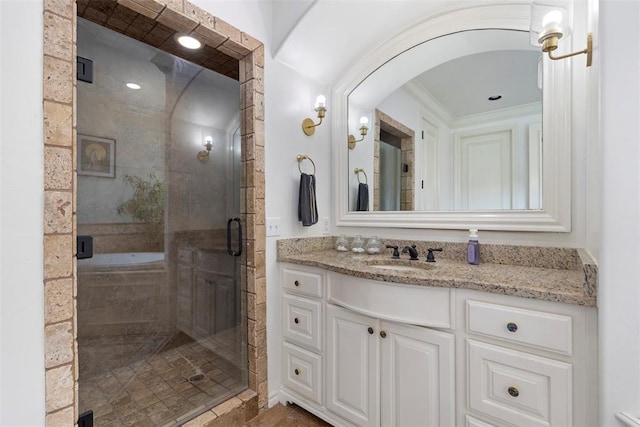 bathroom featuring vanity and an enclosed shower